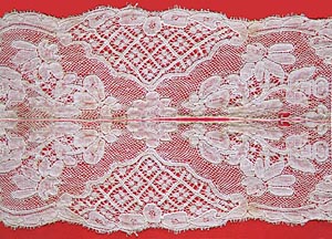 Two strips of Mechlin lace placed side-by-side and sewn together along the long edges so that the pattern on the top strip is a mirror image of the pattern on the bottom strip.
