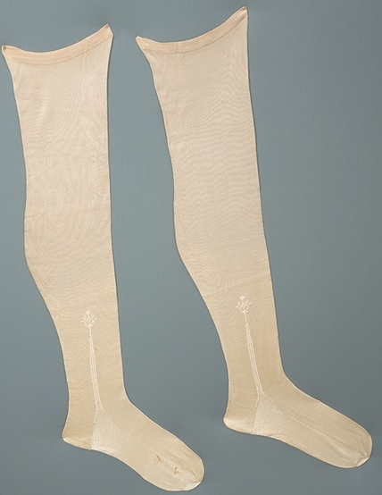 Off-white silk stockings with embroidery on each ankle.